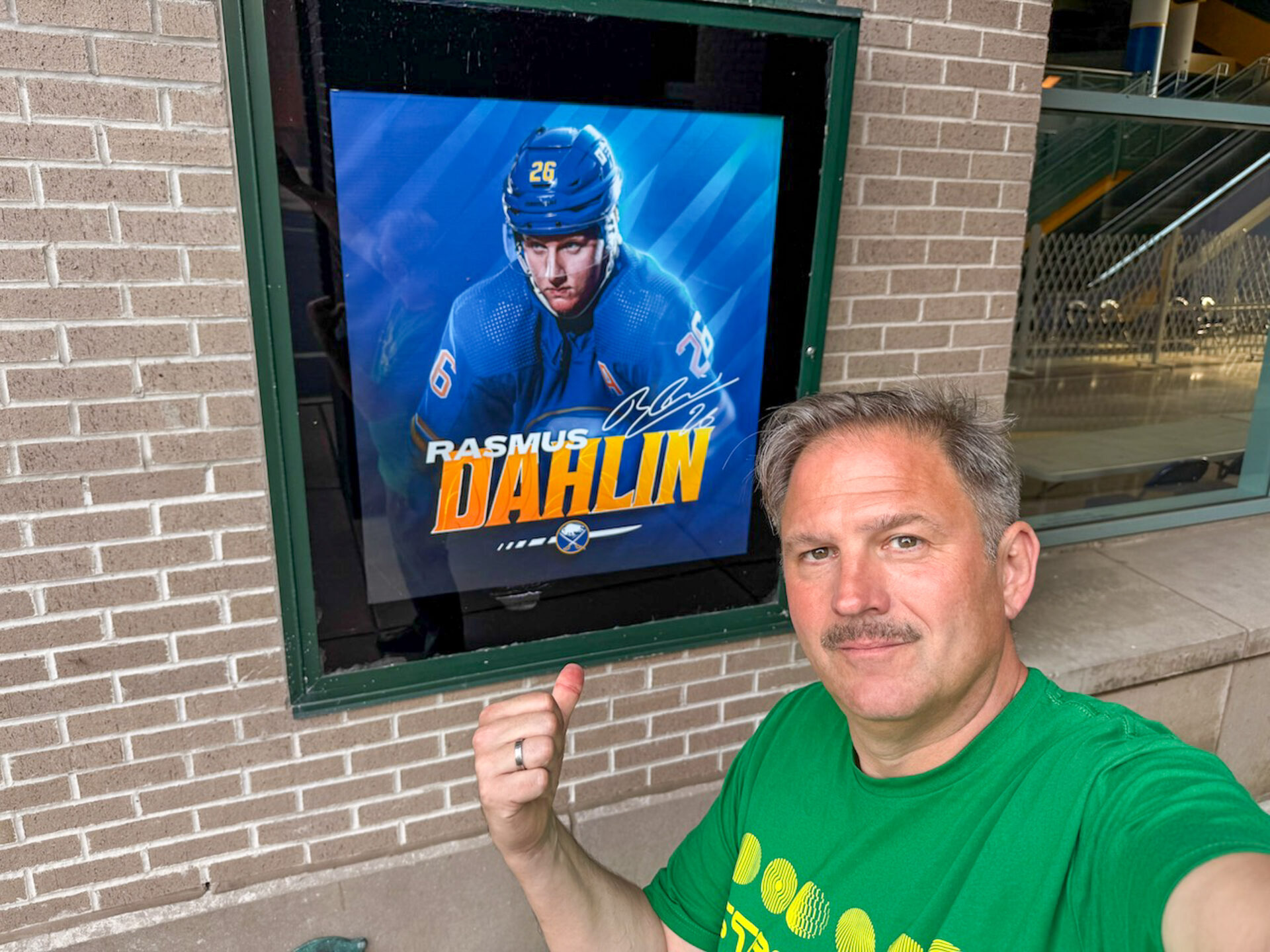 Autor Ralf vor einem Poster von Rasmus Dahlin, Kapitän der Buffalo Sabres 
