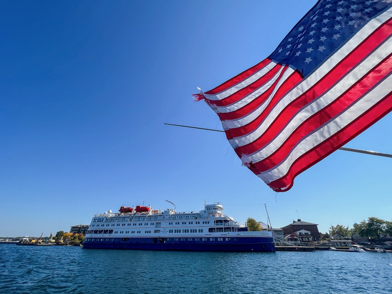 Amerikanische Flagge mit Ausflugssschiff auf dem St. Lorenz-Strom